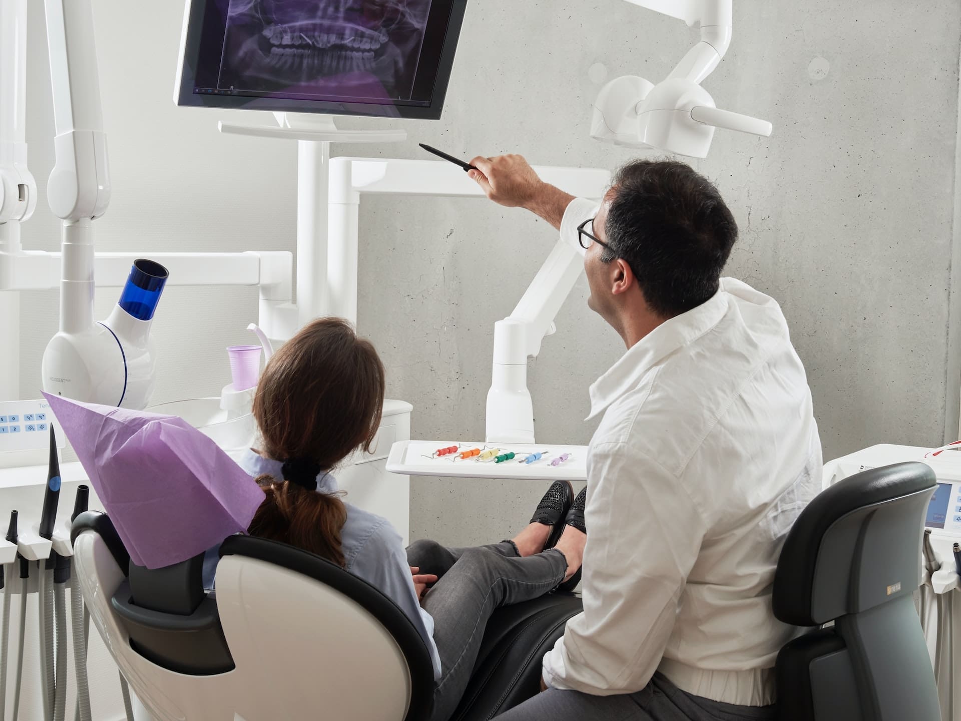 dentist showing patient xray of teeth